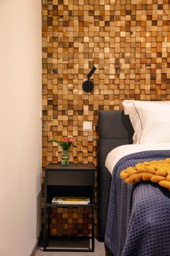 a bedroom with a bed and a vase of flowers on a night stand at LOFT 188 Luxury Apartment Hotel in Utrecht