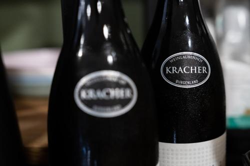 two bottles of wine sitting next to each other at KRACHER Guesthouse No 6 - inklusive Pool in Illmitz