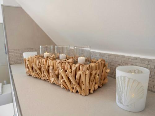 a candle holder with candles in it on a counter at Mönchguter Reethus mit Wasserblick, Kamin, Sauna in Alt Reddevitz