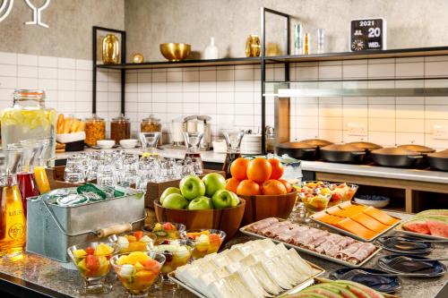 a kitchen with a bunch of food on a counter at Aparthotel Adagio London Sutton Point in Sutton