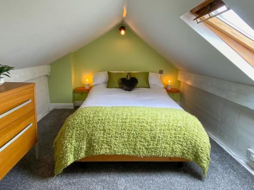 a bedroom with a bed with a cat sitting on it at 'Llandudno Central' - 2 Bed Luxury Flat, Close to Town and Beaches in Llandudno