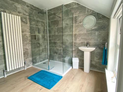 a bathroom with a shower and a sink at 'Llandudno Central' - 2 Bed Luxury Flat, Close to Town and Beaches in Llandudno