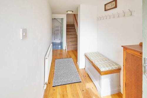 a hallway with a stairway with a bench in a room at Mary Lyth - Whitby West Cliff with parking in Whitby