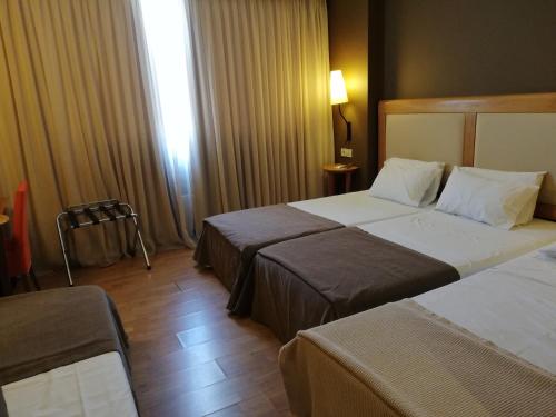 Ένα ή περισσότερα κρεβάτια σε δωμάτιο στο Olympic Hotel 