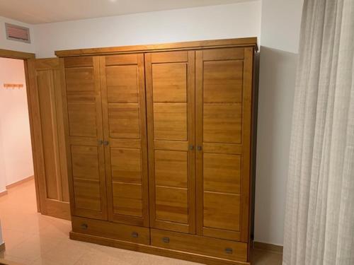 a large wooden cabinet in the corner of a room at VUT SEGEDA Valle del Manubles in Calatayud