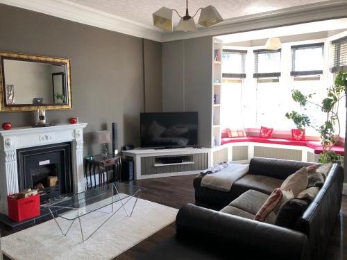 a living room with a couch and a fireplace at Royal Bank Flat in Oban
