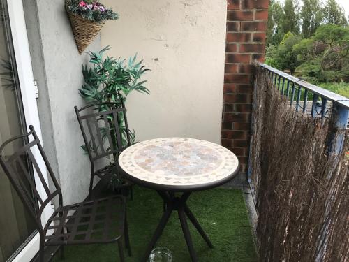 a table and two chairs on a balcony at Acorn Guest House in Hull in Hull