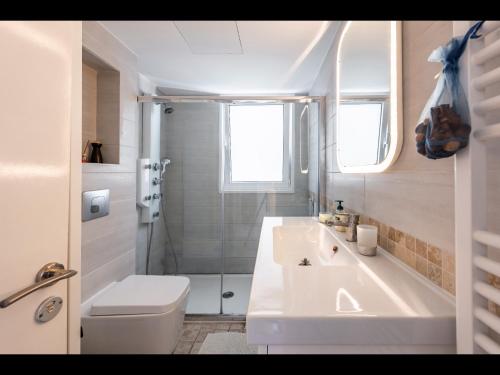 a bathroom with a toilet and a sink and a shower at Myria Court in Limassol