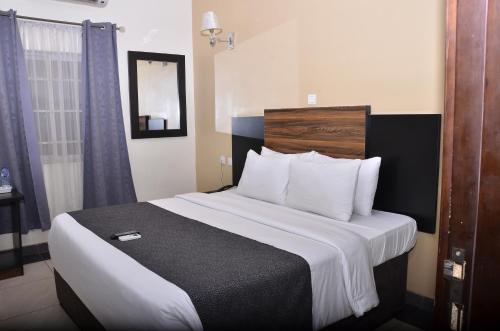 a hotel room with a large bed in it at Residency Hotels Enugu Independence Layout in Enugu