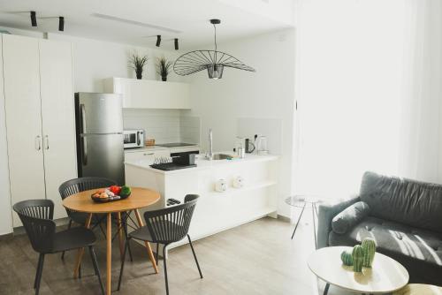 a kitchen and living room with a table and chairs at The Rambam Residence - By Localz Group in Tel Aviv