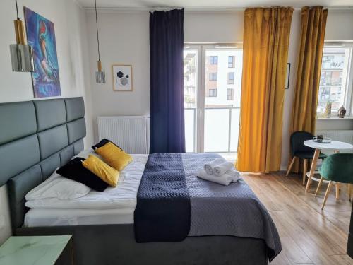 a bedroom with a bed with two towels on it at Apartment Jana Kazimierza Wola in Warsaw