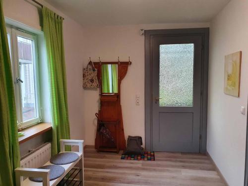 a room with a door and a chair and windows at Das Fachwerkhäuschen in Bad Pyrmont