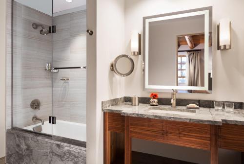 a bathroom with a sink and a shower at Rosewood Inn of the Anasazi in Santa Fe