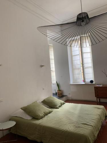 a bedroom with a large bed with a large umbrella at Liberté in Marseille