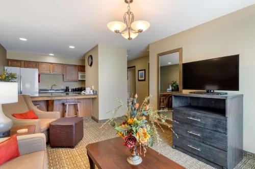 a living room with a large flat screen tv at Comfort Inn & Suites Ponca City near Marland Mansion in Ponca City