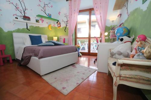 a childs bedroom with a bed and a table at Bari Suite Apartment Barone 12 in Bari