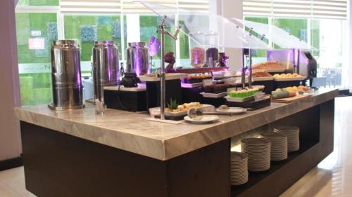 a buffet line with plates and food on display at Swiss-Belinn Tunjungan Surabaya in Surabaya