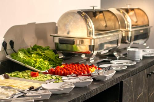 a buffet with tomatoes and vegetables on a table at THE NOVA HOTEL in Yalova