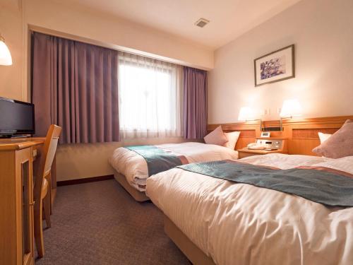 Säng eller sängar i ett rum på Hotel Areaone Wadayama