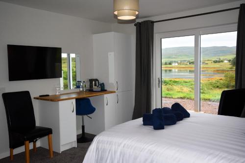 a bedroom with a bed and a window with a view at Treaslane Bridge House in Kensaleyre