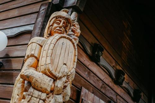 a wooden statue on the side of a building at Berghaus Turracherhöhe in Turracher Hohe