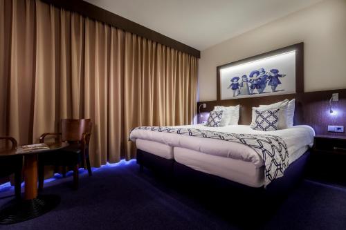 Een bed of bedden in een kamer bij Hotel Die Port van Cleve