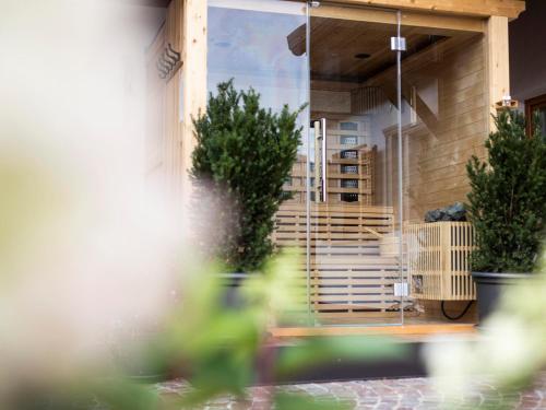 a building with potted plants on a patio at Apartment Andreas - Gallhof in Vollan
