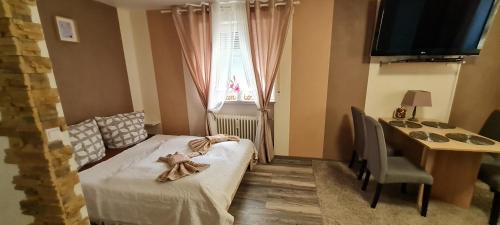 a small bedroom with a bed with a teddy bear on it at Nürnberg Apartment in Nuremberg