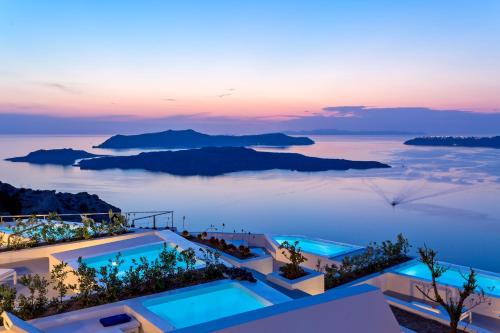 een uitzicht op de oceaan vanuit een villa bij zonsondergang bij Alti Santorini Suites in Megalokhori