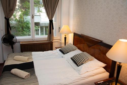 a hotel room with a bed and a lamp at Evergreen Budapest Guest House in Budapest