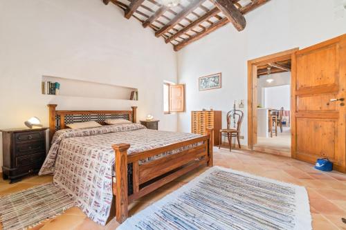 a bedroom with a bed with a wooden frame at "On the roofs of Trapani" Roomy Flat in Trapani