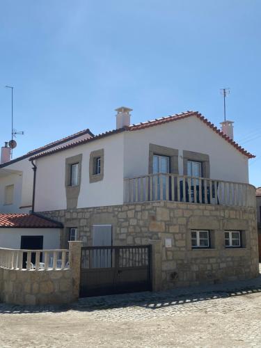 a large white house with a fence in front of it at Casa da Clemencia in Cardeal
