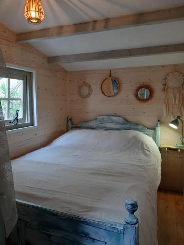 a bedroom with a bed in a log cabin at Little Beach House - Free parking in Zandvoort