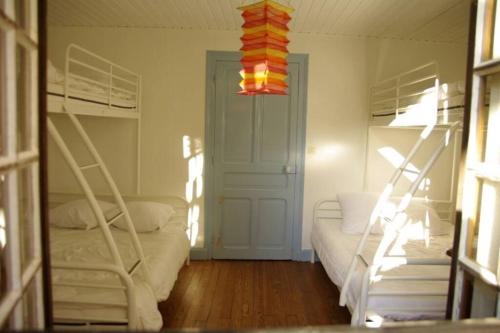 a bedroom with two bunk beds and a chandelier at Moulin dans un parc d’élevage à Daims in Jancigny