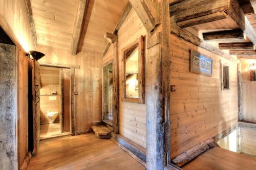 a log cabin hallway with wooden walls and wood floors at IMMOBILIER DE MONTAGNE - LA COLLECTION - L'alpage in Saint-Gervais-les-Bains