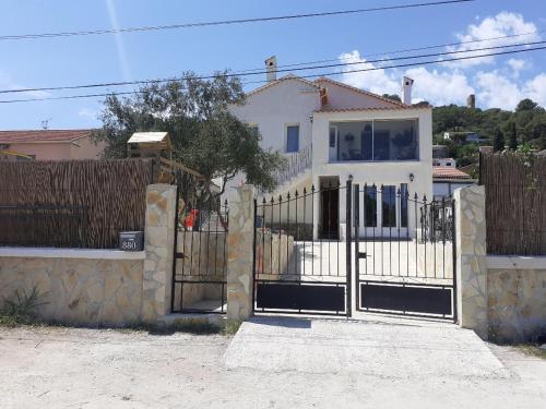 ein Tor vor einem weißen Haus in der Unterkunft Almanarre in Hyères