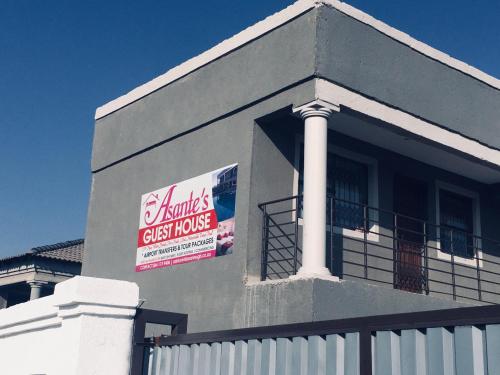 a house with a sign on the side of it at Asante’s Guest House in Calcutta