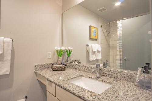 a bathroom with a sink and a mirror at 2 Bedroom Fully Furnished Apartment near Emory University Hospital Midtown in Atlanta