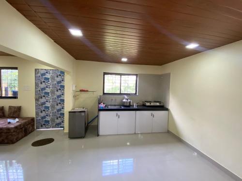 a large room with a kitchen and a living room at Farmhouse in Pune city in Pune