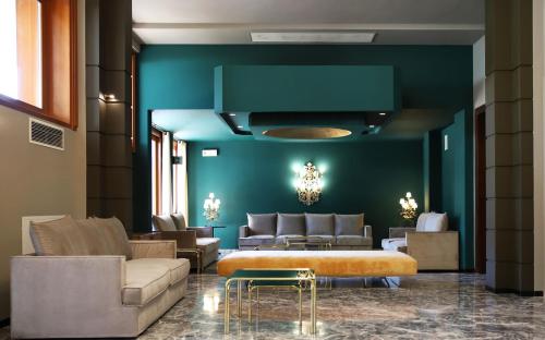 a living room with a couch and a table at Hotel Terme Delle Nazioni in Montegrotto Terme