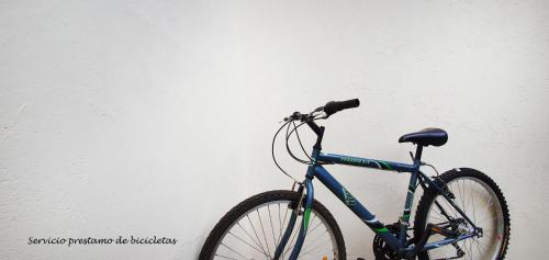 a blue bike parked next to a white wall at Hotel Santa Clara in Santiago de Compostela