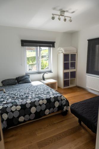 a bedroom with a bed and a window at La villa de Spa in Spa