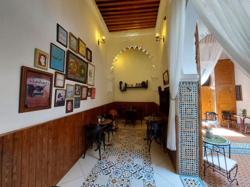 a restaurant with tables and chairs in a room at Riad & Café culturel BAB EL FAN in Tétouan