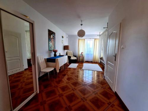 a living room with a table and a dining room at Willa Puńsk z basenem nad jeziorem in Puńsk