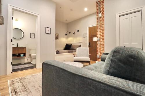 a living room with a couch and a bedroom at The Queen Suite at Prince Street Inn in Alexandria