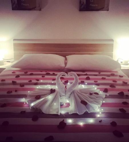 a bed with two swans dressed in white at Arija in Bilice