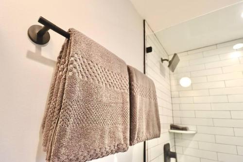 a bathroom with a towel hanging on a shower at The Fairfax Suite at Prince Street Inn in Alexandria