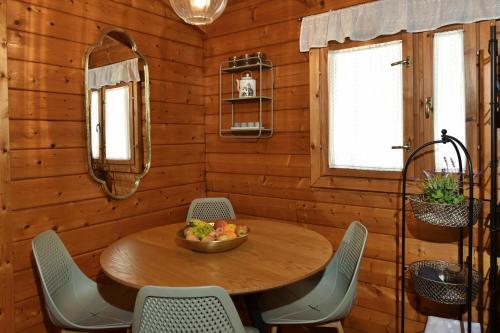 a dining room with a wooden table and chairs at בקתות בית מאיר אבירים - זמן בריאה in Abirim