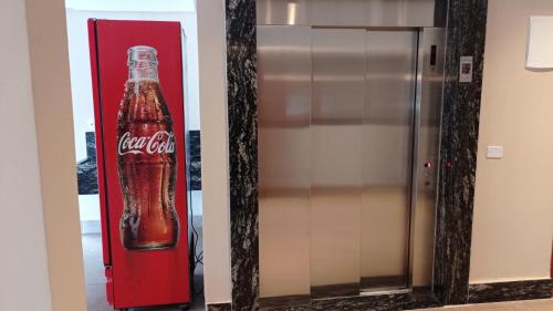 a coca cola bottle on the wall of a elevator at Hotel Marina Torrano in Trindade
