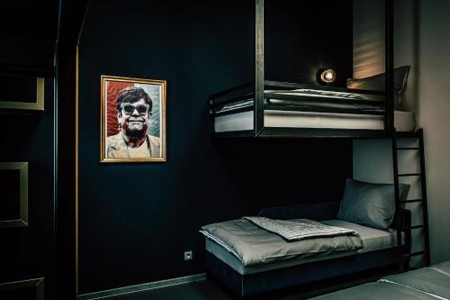 a room with a bunk bed and a picture of a man at Boutique Apartments OLD SCHOOL in Söll